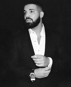 a man with a beard wearing a suit and watch