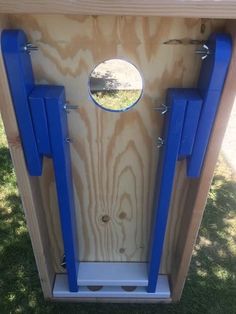 a wooden structure with blue handles and mirrors