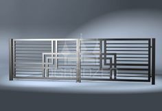 an image of a metal gate that is in the middle of a room with grey walls