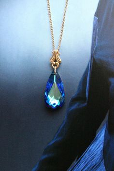 "https://www.tresajewelry.etsy.com Swarovksi crystal drop necklace with filigree detail shown in gold with Bermuda Blue. Rich in color and beautifully cut, this crystal stone is quite eye catching. This piece is very versatile, can be worn dressed up or dressed down-- easily transitions from day to night.  Create a matching set with https://www.etsy.com/listing/105430167/rivoli-cut-vintage-swarovski-crystal Specifications: --Crystal is 24 x 12mm in size.  --Chain is 20\" in length with an adjust Handmade Elegant Drop Crystal Necklaces, Elegant Handmade Teardrop Crystal Necklace, Elegant Teardrop Crystal Necklaces For Jewelry Making, Elegant Blue Dangle Crystal Necklaces, Elegant Blue Teardrop Crystal Necklace, Head Necklace, Teardrop Necklace, Crystal Drop, Crystal Stone