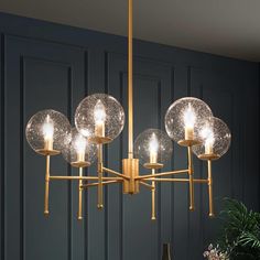 The 6-Light Modern Gold Chandelier by Uolfin Lighting is a modern design that combines classic elements. This Sputnik glass chandelier light displays modern beauty with its chic appeal. The dining room chandelier takes a pretty brass gold color finish, the candlestick lamp holder design offers a more traditional look, while the Sputnik element stands for popular trend. An enchanting essence will fill your space from your kitchen island to your living room; this rustic globe chandelier offers a p Gold Chandeliers Dining Room, Modern Gold Chandelier, Circle Chandelier, Dining Room Light Fixture, Gold Dining, Mid Century Chandelier, Classic Chandelier, Dining Room Light Fixtures, Globe Chandelier