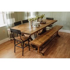 a wooden table and bench in a room