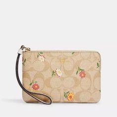 Coach Floral Daisy Print Light Brown / Cream Colors Signature Coated Canvas And Smooth Leather Two Credit Card Slots Zip-Top Closure, Fabric Lining Wrist Strap Attached Gold Hardwear 6 1/4" (L) X 4" (H) X 1/2" (W) Coach Spring Pouch Wallet, Coach Pouch Wallet For Spring, Beige Wallets For Spring, Coach Beige Bag With Zipper Pouch, Spring Wallets With Removable Pouch, Spring Wallet With Removable Pouch, Coach Floral, Ditsy Print, Signature Canvas