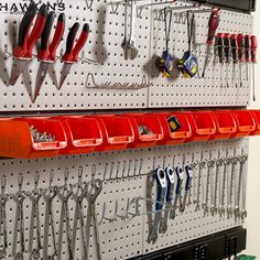 there are many tools hanging on the wall