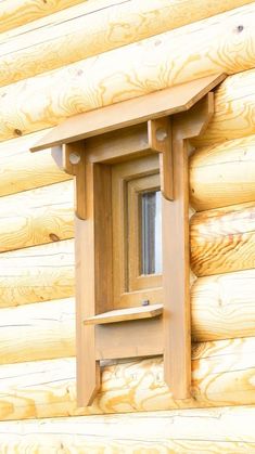 a window in the side of a log cabin