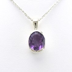 This genuine faceted 9x11mm oval amethyst gemstone in set in a sterling silver pendant setting. Pendant is 3/4 inch long and 3/8 inch wide and comes on an 18 inch long silver diamond cut cable chain. To clean: simply use a jewelry polishing cloth to brighten the silver when needed. Style Number: 16603 Metal: 925 Sterling Silver Gemstone: Genuine Amethyst Dimensions: 3/4 inch long and 3/8 inch wide, 18 inch chain Elegant Oval Necklace With Large Stone, Sterling Silver Oval Necklace With Diamond Cut, Oval Sterling Silver Necklace With Diamond Cut, Sterling Silver Jewelry With Diamond Cut Oval Pendant, Purple Oval Diamond Cut Jewelry, Oval White Gold Jewelry With Large Stone, Oval Purple Diamond Cut Jewelry, Oval Faceted White Gold Jewelry, Faceted Oval Sterling Silver Necklaces