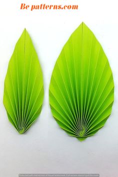 two green leaf shaped paper pieces on a white background with the words be patterns com