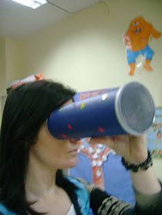 a woman with long black hair holding a blue cup