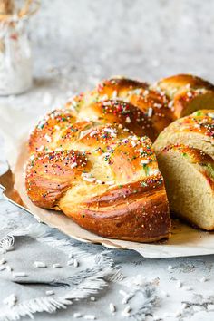 a loaf of bread with sprinkles on it sitting on top of a plate