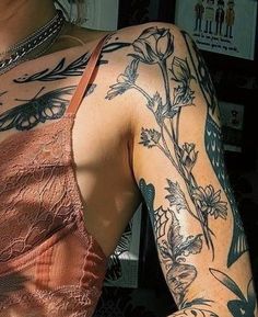 a woman with tattoos on her arm and shoulder