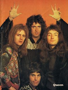 an album cover with the band queen on it's front and two hands in the air