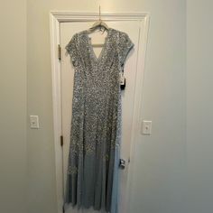 New With Tags. Size 12. Silver Maxi Dress For Evening, Silver Floor-length Prom Dress, Silver Maxi Dress For Formal Occasions, Silver Maxi Evening Dress For Prom Season, Silver Embellished Holiday Evening Dress, Formal Silver Maxi Dress, Embellished Silver Floor-length Gown, Elegant Silver Maxi Evening Dress, Silver Gala Evening Dress