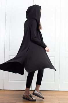 "Wool Cape, Knit Cardigan, Cloak with Hood This asymmetrical and modern cloak with hood has two side pockets, super comfy hood and thumb holes for a fabulous look. The model in the picture is 168cm. ⅼ 5.6 ft. tall and is wearing size S / color: black 🌟 INFO: * Worldwide EXPRESS shipping - please provide a phone number for shipping documents * US Sizing XS to 4XL - body size chart available below * We offer customization to Personal Measurements & Larger Sizes 5XL, 6XL, 7XL .... 🌟 MATERIAL Winter Long Sleeve Solid Color Cape, Casual Long Sleeve Cape For Layering, Cozy Long-sleeve Winter Cape, Cozy Long Sleeve Winter Cape, Cozy Winter Cape, Oversized Hooded Cardigan For Layering, Winter Stretch Asymmetrical Sweater, Asymmetrical Stretch Sweater For Winter, Stretch Asymmetrical Sweater For Winter