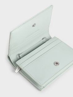 Wallets are great starter pieces to start introducing more colours into your wardrobe. The ultra-compact silhouette of this sage-green wallet is paired with plush and padded square quilts for a touch of tactility to create a soft design that is a treat to use every day. Generously sized for multiple cards and folded note bills, slot it into your everyday bags or attach the delicate chain strap to convert it into a micro bag. Luxury Green Wallet With Coin Pocket, Square Quilts, Folded Note, Micro Bag, Soft Design, Mini Accessories, Cute Wallets, Brand Collaboration, Delicate Chain