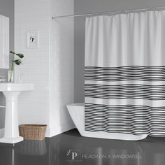 a black and white striped shower curtain in a bathroom