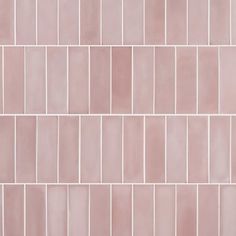 a close up view of a pink tile wall