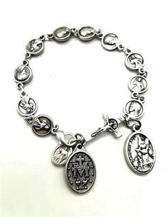 Rosary bracelet is made with silver dipped Divine Mercy medals,medal of Virgin Mary, St Michael / Guardian Angel and a cross.It is handmade in Medjugorje at the base of Apparition Hill, where it is reported that the Blessed Virgin Mary started appearing to a group of children in 1981.Medals made in Italy. Bracelet can be adjusted with clasp, but if you want specific size,please send me a note with your size and it will be done.Wear this chaplet on your wrist to remind yourself that God has given Adjustable Silver Rosary Bracelet With Miraculous Medal, Spiritual Rosary Bracelet With Miraculous Medal, Spiritual Silver Rosary Bracelet With Charms, Spiritual Silver Rosary Bracelet With Miraculous Medal, Italy Bracelet, Jesus Clothes, Angel Bracelet, Custom Gift Cards, Catholic Women