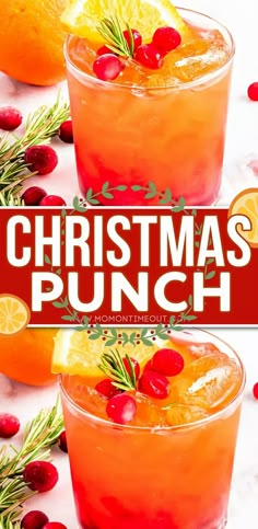 two glasses filled with christmas punch and garnished with cranberries, oranges and rosemary