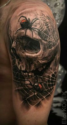 a man with a skull and spider web tattoo on his arm