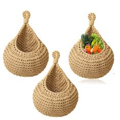 three baskets with handles are shown on a white background and one has vegetables in it