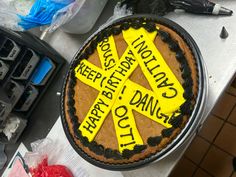 a cake that has been decorated with yellow ribbon and some writing on the frosting