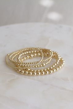 "❖MYLA BRACELET❖ *The all day-everyday-stackable bracelet!  ‣Our Myla Bracelets Feature:  *14k-Gold Filled Beads (high-quality, water + tarnish resistant, perfect for everyday wear!) *Available in 5 sizes: 2mm, 3mm, 4mm, 5mm, 6mm *Single larger bead (2mm + 6mm, 3mm + 5mm, 4mm + 6mm, 5mm + 7mm, 6mm + 8mm) *Tight/Sturdy elastic, pre-stretched to prevent bracelet from stretching out ‣Sizing Tips:  Please measure your wrist for the best fit!  *Using a soft tape measure/string, measure around your wrist, above the wrist bone *Add length according to your desired fit:       * 0\" - fitted, snug      * .25\" - slight movement      * .5\" -  comfortable movement      * .75\"- loose      * 1\" - extra loose *Please message us if you need any help with sizing!  ------- ‣Each bracelet is made to orde Gold Minimalist Stretch Bracelet With Tiny Beads, Minimalist Gold Stretch Bracelet With Tiny Beads, Everyday Stackable Gold Beaded Bracelets, Everyday Gold Stackable Beaded Bracelets, Gold Stackable Stretch Bracelet For Layering, Gold Stretch Bracelet For Layering, Minimalist Everyday Stretch Bracelet With Gold Beads, Everyday Stretch Bracelet In 14k Gold-filled, Dainty 14k Gold Filled Stretch Bracelet For Everyday