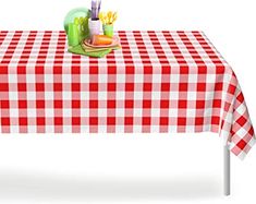 a red and white checkered table cloth with utensils on it