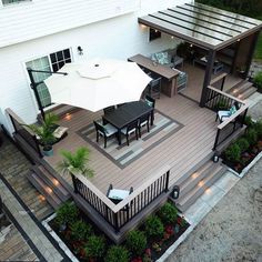 an aerial view of a deck with patio furniture and umbrellas on it's sides