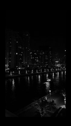 black and white photograph of city lights at night