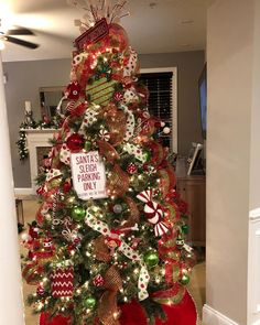 a christmas tree decorated with red, green and gold ornaments