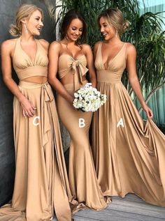 three beautiful women in long dresses standing next to each other