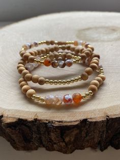 Our PUMPKIN SPICE stack! These are super stylish, comfortable and perfect for FALL! Such a trendy boho-look! (These are meant to fit snug. If you would like them to feel loose and move around on your wrist, please size up). Each bracelet is carefully handmade with high quality materials: -6mm natural Agate stones in Fall colors -6mm natural wood beads -3mm gold hematite beads -7mm black/gold acrylic letters -Cord: high-quality, durable, stretch cord with reinforced knots and specialty glue ⭐️⭐️W Handmade Agate Beaded Bracelets For Everyday, Everyday Handmade Agate Beaded Bracelets, Gold Bracelets With Wooden Beads For Healing, Handmade Agate Bracelets For Everyday, Everyday Beaded Agate Bracelets, Everyday Agate Beaded Bracelets, Handmade Natural Wood Beaded Bracelets, Everyday Agate Beaded Bracelet, Handmade Adjustable Beaded Bracelets In Natural Wood