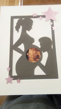 a man and woman are silhouetted in the shape of a frame with pink stars