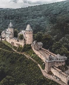 an aerial view of a castle on top of a hill