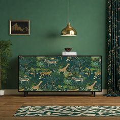 a living room with green walls and animal print on the sideboard next to a rug