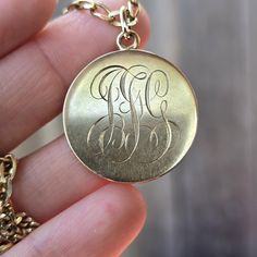 **Chain is not included** Circle locket made from 14 karat solid yellow gold. This locket is a dream. On one side it's hand engraved with initials which I depict to be "JFG." I'm always so drawn to hand engraved initials.  The inside surprisingly still has plastic inserts intact to hold a photo/ hair, etc. On the other side is an engine turned linear design. The edge is skillfully also hand engraved. It's just amazing. It opens to the right of the engine turned so the monogram is meant to be on the backside but honestly I personally would wear it either way.  It's about 1 inch across and weighs weighs 6.5 grams Ships free out of Southern California Circle Locket, Photo Hair, Engraved Initials, Linear Design, Dream On, Locket Necklace, Hand Engraving, Just Amazing, Solid Yellow