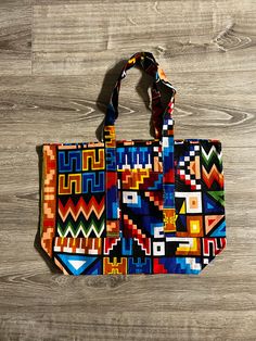 These are tote bags made in Ghana by my sister. She picked these specific fabrics based on their vibrance and versatility. Perfect gift for the holidays.  ** Specifications ** 10.5in. H x 17.5 in. W x 5.5in D. Wax Print  2 outside Pockets Multicolor Canvas Shoulder Bag For Gifts, Rectangular Multicolor Beach Bag For Everyday Use, Multicolor Square Beach Bag For Everyday, Multicolor Reversible Canvas Bag For Everyday Use, Large Multicolor Beach Bag For Everyday Use, Multicolor Handmade Canvas Bag For Daily Use, Colorful Cotton Bags For Everyday Use, Multicolor Everyday Beach Bag, Multicolor Square Canvas Bag For Everyday Use