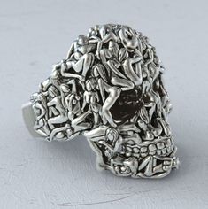 Whether you're a collector of unique gothic pieces or looking to add a bold edge to your outfit, this ring is sure to be a conversation starter. Made for the individual who embraces their uniqueness and isn't afraid to stand out. Handmade Unique Metal Skull Ring, Silver Artistic Rings With Artistic Design, Artistic Silver Rings With Artistic Design, Artistic Adjustable Rings, Artistic Metal Rings With Unique Design, Unique Handmade Skull Ring, Lesbian Ring, Index Finger Rings, Silver Skull Ring