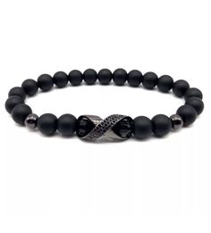 "Simple and elegant this black onyx bracelet is made with 8mm natural stones, combined with black stainless steel charm and beads, beaded in elastic cord 1mm  Fits size 8\"-9\"" Modern Black Round Bead Bracelets, Casual Black Hematite Jewelry, Modern Black Bracelets With Black Beads, Modern Black Bracelets With 8mm Beads, Black Wristband With 8mm Beads, Modern Black Bracelet With 8mm Beads, Modern Black Bracelets With Gemstone Beads, Casual Black Stretch Bracelet With Gemstone Beads, Elegant Black Hematite Bracelets