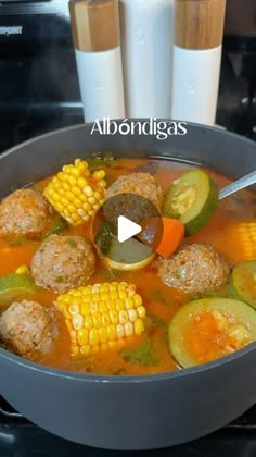 a pot filled with soup and vegetables on top of a stove