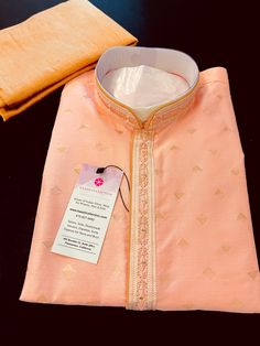 Designer Baby color Raw Silk Kurta Pajama Set. - Ready to Wear Pink color/ Baby Pink Color Men Kurta Pajama Set in Raw Silk material.- Kurta has Lining and Hand embroidery Work on the neckline and Collar.- Real Mirror Work on the Neckline and Collar of the Kurta.- Kurta comes with Free Size Churidar Bottom.Disclaimer -For sizing please refer to the Size Chart given in the listing with the pictures. - Please do NOT go by the size of the Kurta that you already have from another maker. All makers h Ceremonial Fitted Sherwani With Zari Weaving, Fitted Orange Kurta For Transitional Seasons, Orange Sherwani For Wedding Eid Festival, Orange Sherwani For Wedding At Eid, Orange Sherwani For Wedding And Eid, Transitional Season Fitted Orange Kurta, Transitional Season Orange Fitted Kurta, Fitted Kurta With Zari Weaving For Traditional Ceremonies, Fitted Art Silk Kurta For Traditional Ceremonies