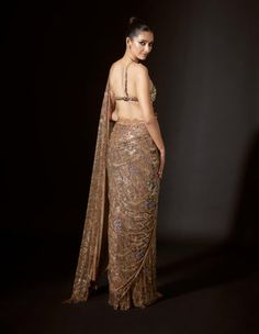 Festive Gold Embellished Pre-draped Saree, Gold Pre-draped Saree For Diwali Reception, Elegant Gold Pre-draped Saree For Festivals, Gold Embellished Choli, Gold Pre-draped Saree With Sheer Dupatta For Diwali, Embellished Gold Choli, Gold Saree With Intricate Embroidery For Party, Gold Saree With Dupatta For Reception, Glamorous Traditional Wear With Zari Work For Reception