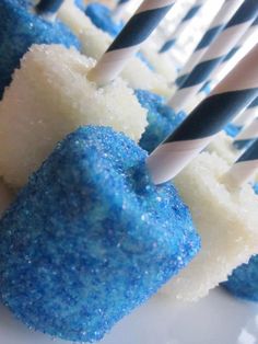 blue and white cake pops are on a plate