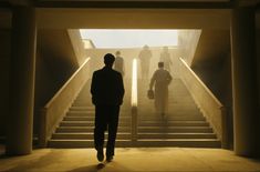 two men are walking up some stairs