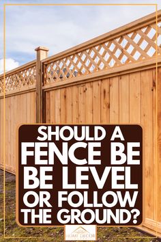 a sign that says should fence be level or follow the ground? in front of a wooden fence