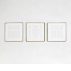 three framed photographs hang on the wall next to each other in an empty room with white walls