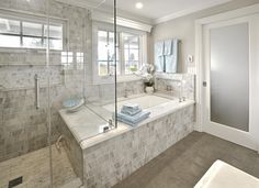 a bath room with a tub a sink and a window