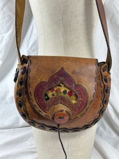 "Measurements are 8\" wide, 7\"5 high, 1\"5 deep with one 31\"5 shoulder strap with a 13\" drop.  On the interior there is one main compartment with a front flap closure. The leather on this purse is thick and strong with lovely hand tooled front along with front tapestry flap and brown leather weave. Bag is vintage and in fair to good condition with some water spots with no tears and will last you for years to come. Bag is one of a kind from the 1970s.  ----------------------------------------I Weave Bag, Leather Weave, Structured Shoulder, Leather Weaving, Leather Tooling, No Tears, Fun Bags, Tan Brown, The 1970s