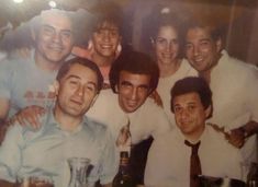 a group of men and women posing for a photo