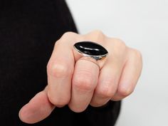 BLACK ONYX RING This ring is solid and weighty, polished to a mirrored finish. Details: 925 Sterling silver 15mm (Approximate Band Width) 10mm (Approximate Band thickness) Black Onyx (Center Stone) Marquise 27X13mm (Center Stone Dimensions) 32 Grams (Average Total Weight) Hypoallergenic ( Nickel free ) Larger size is available, please contact us. All jewelry comes in beautiful packaging, ready to give, just perfect for that special gift! Want to see more item? www.etsy.com/shop/Lessaremore Feel Black Onyx Rings With Polished Finish, Crystal Ear Cuff, Thumb Rings Silver, Basic Jewelry, Chevron Ring, Snake Jewelry, Silver Ear Cuff, Black Onyx Ring, Large Ring